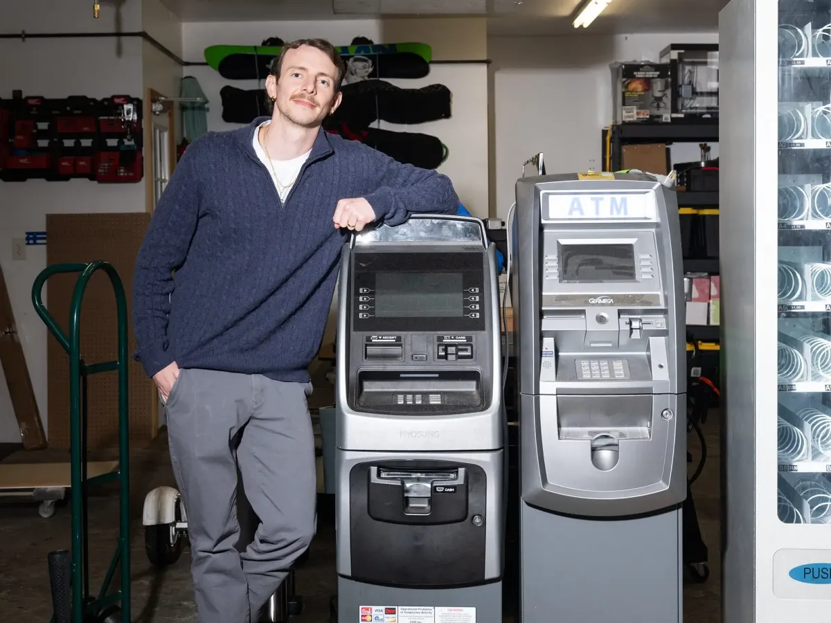 Will Butterton beside ATM Machines